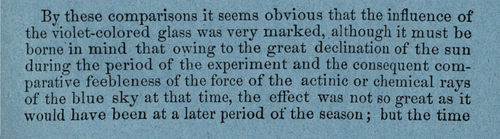 Close-up of a printed paragraph on blue-tinted paper discussing experimental comparisons of violet-colored glass. The text notes the marked influence of blue and chemical rays of the sky, while acknowledging seasonal limits due to the sun’s position during the experiment.